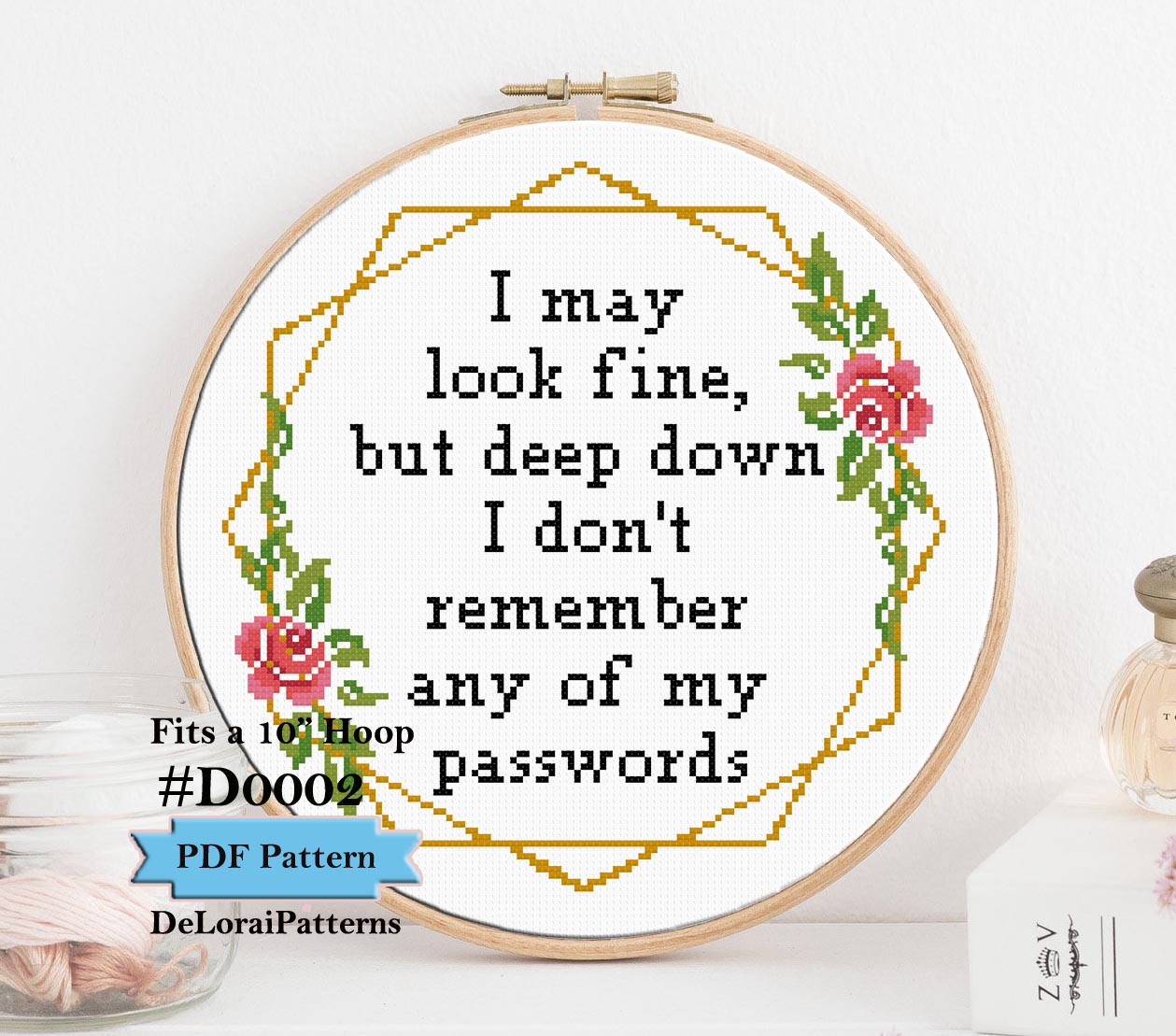 A completed modern office cross-stitch pattern framed in a wooden hoop that features the funny prase I may look fine but deep down I don't remember any of my passwords